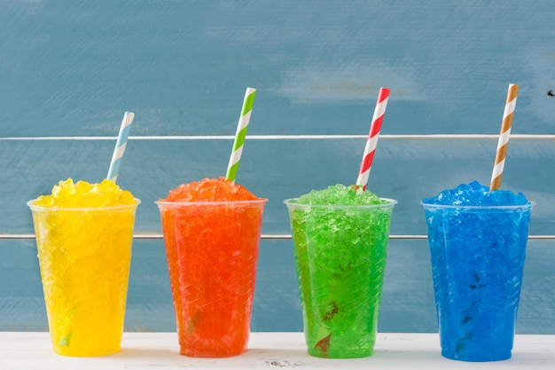 Colorful summer slushies on wooden table