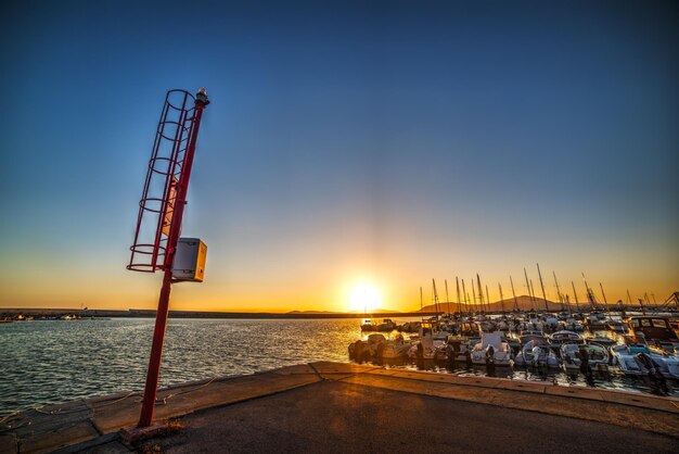 Colorful sunset in Alghero harbor Sardinia