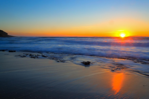 Colorful sunset by the shore in Castelsardo Italy