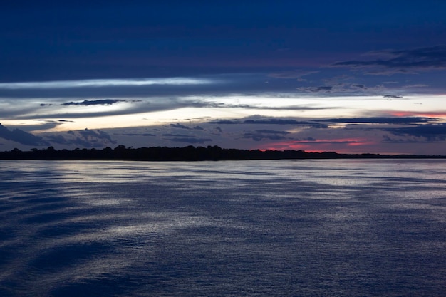 Красочный закат на реке Амазонка в тропических лесах Бразилии