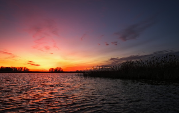 Colorful sunset over sea. Red and orange sky. A long exposure