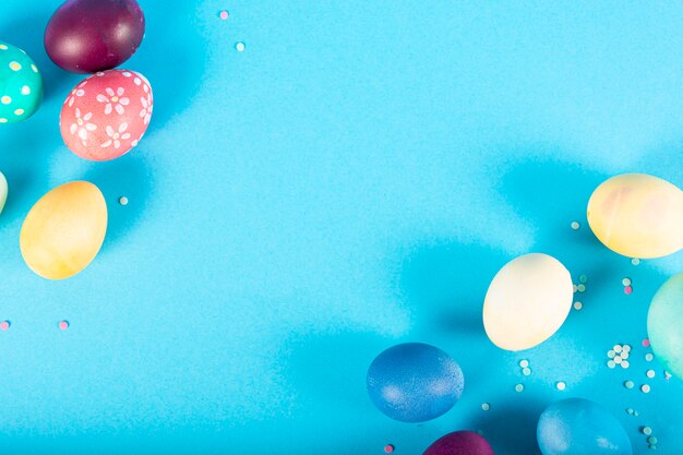 Colorful surface with Easter eggs on blue surface