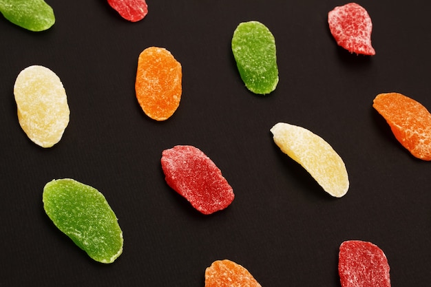 Colorful sweet candied fruit over a black background. Candied dried fruit