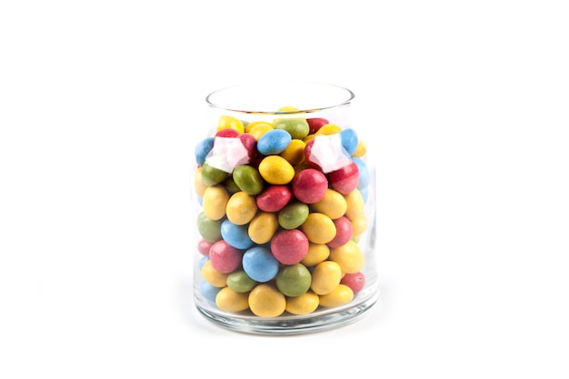 Colorful sweet candies in glass jar isolated on white