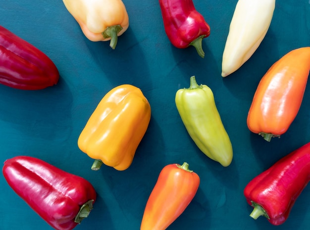 Colorful sweet peppers on a green background A bright poster