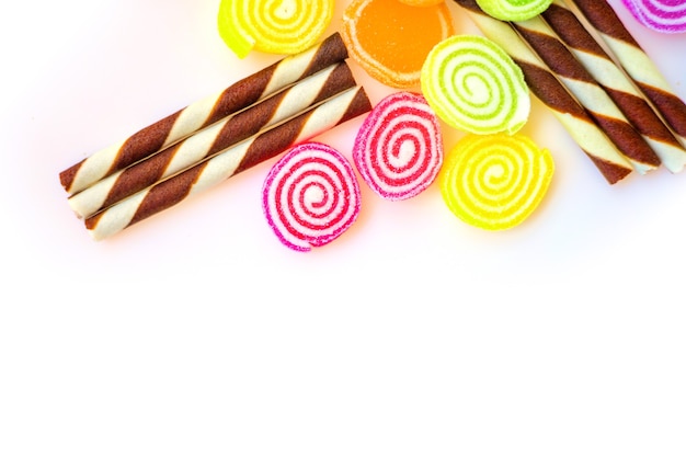 Dolci colorati e caramelle di zucchero su sfondo bianco