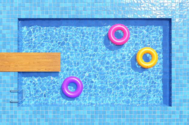 Colorful swimming rings in blue swimming pool