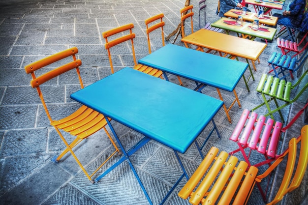 Colorful tables and chairs on the sidewalk in Florence Italy