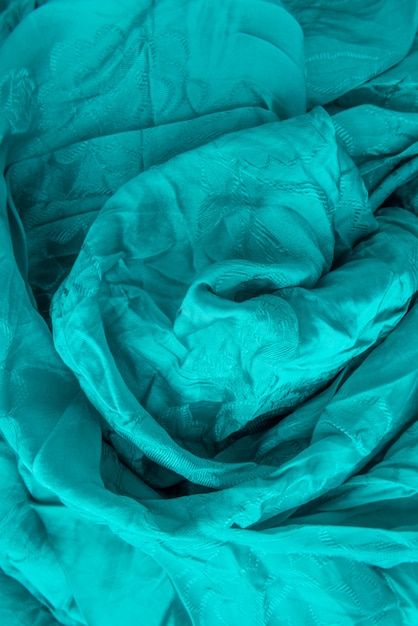 Colorful textile close up in bright green-blue