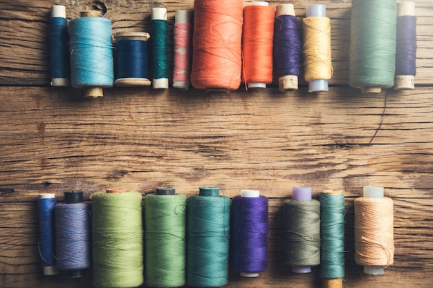 Colorful threads on the wooden table