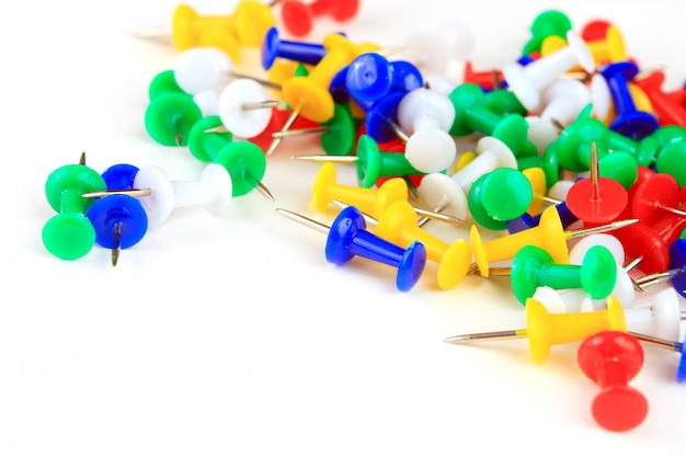 Colorful thumbtacks on a white background