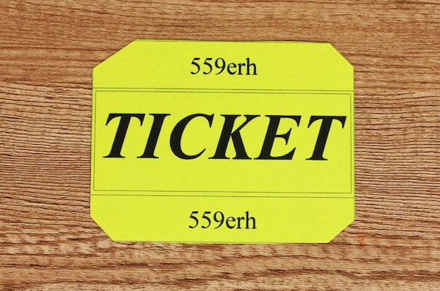 Colorful ticket on wooden background closeup