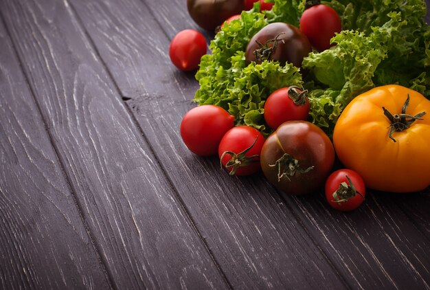 Colorful tomatoes on black background