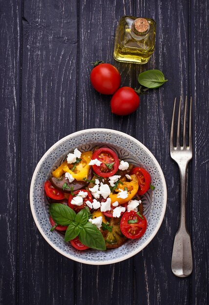 Colorful tomatoes salad with feta cheese. Selective focus