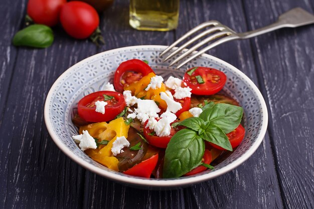 Colorful tomatoes salad with feta cheese