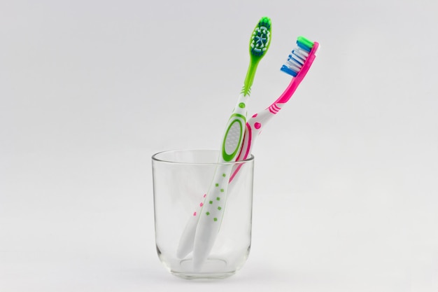 Colorful toothbrushes in a glass beaker