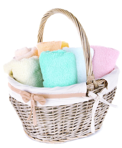 Colorful towels in basket isolated on white