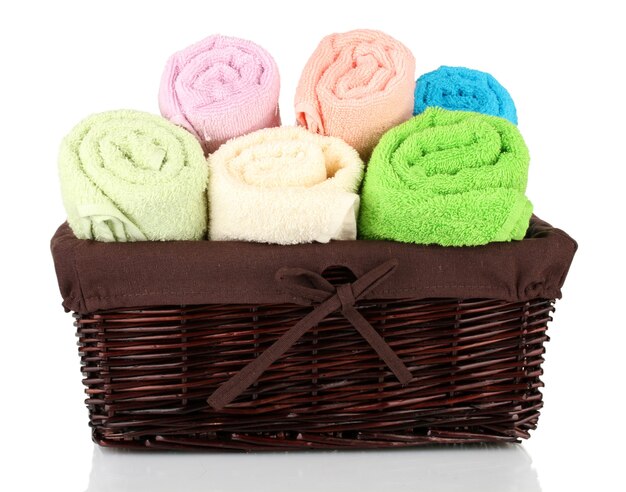 Colorful towels in basket isolated on white