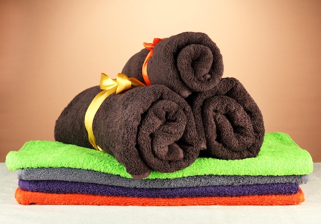 Colorful towels on brown background