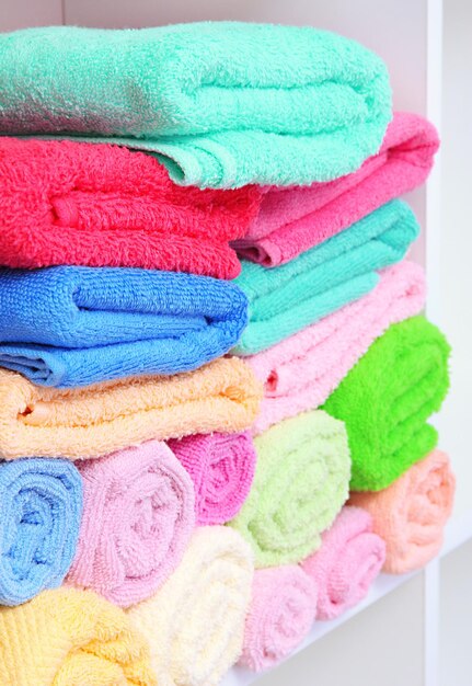 Colorful towels on shelves in bathroom