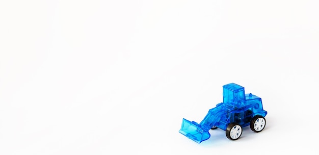 Photo colorful toy blue plastic tractor isolated on a white. blue tractor. toy for children.