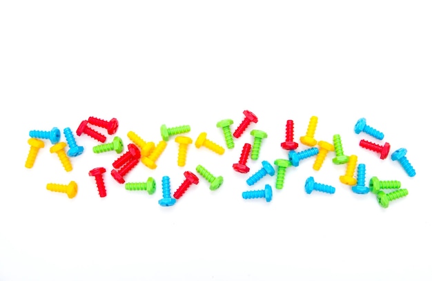 Colorful toy bolts. Construction toys. Background of the screws. Boltiks. Plastic toy.