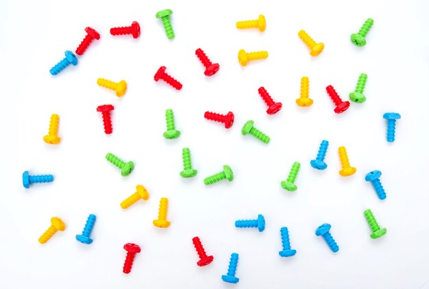 Colorful toy bolts. Construction toys. Background of the screws. Boltiks. Plastic toy.