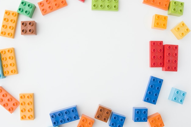 Colorful toy bricks on white background