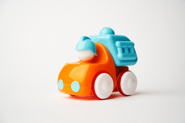 Colorful toy truck on a white surface with copy space. Construction truck toy