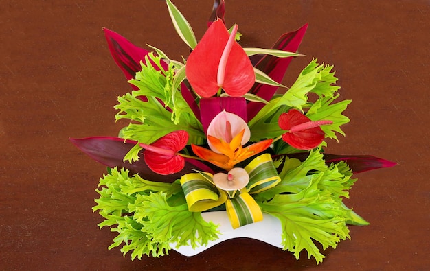 Colorful tropical flowers bouquet arrangement on wooden background