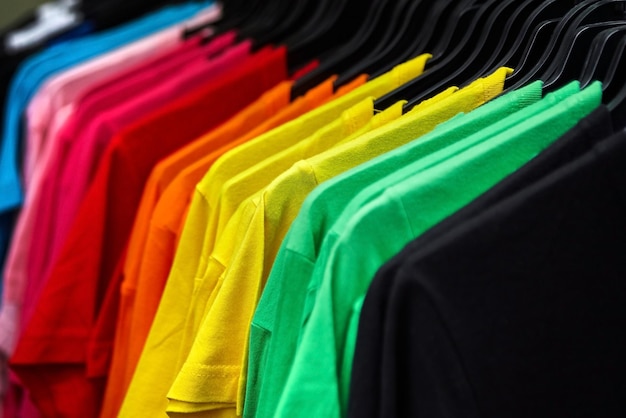 Colorful tshirt for the man on hangers in a retail shop