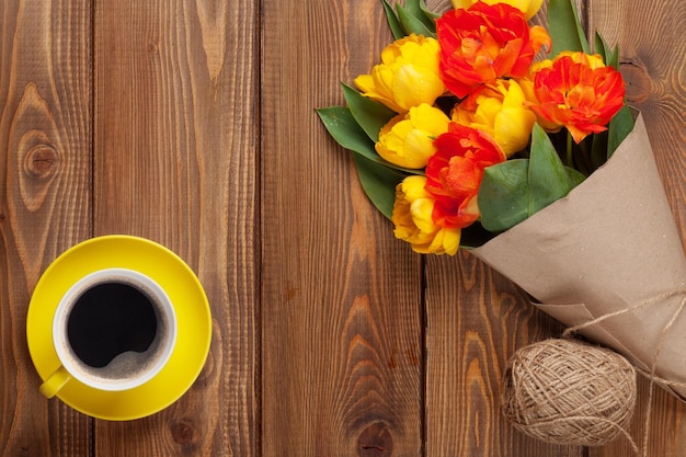 Colorful tulips bouquet and coffee cup