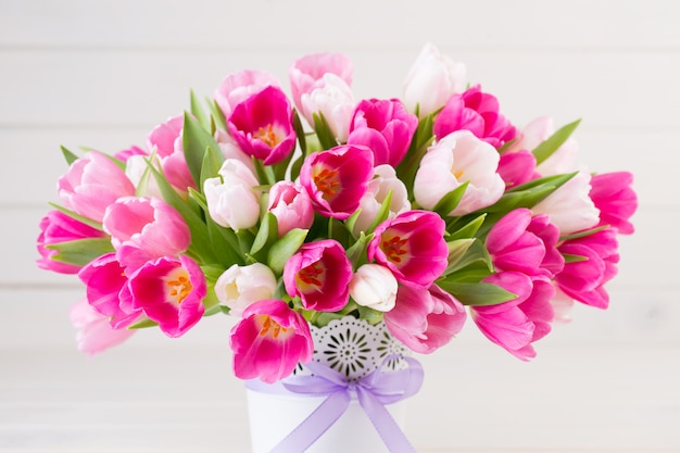 Colorful tulips bouquet on a wooden background