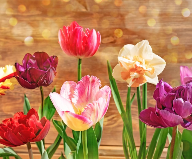 Colorful tulips bouquet on wooden background