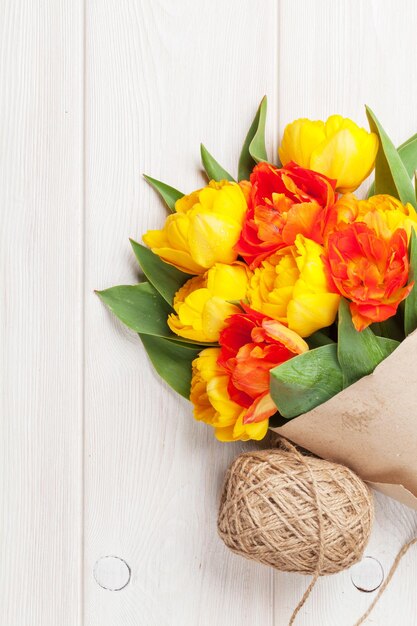 Colorful tulips over wooden table