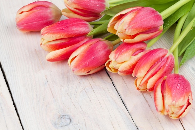 Colorful tulips on wooden table