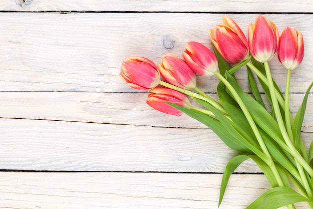 Colorful tulips on wooden table