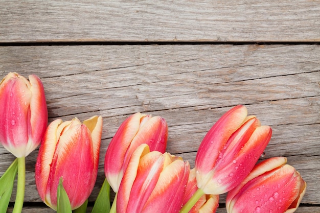 Colorful tulips on wooden table