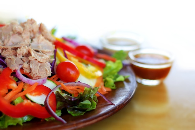 colorful tuna mixed salad serve on wooden plate