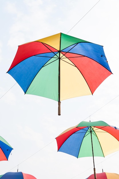 Colorful umbrellas on beautiful sky background