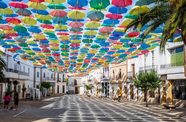 Colorful umbrellas floating in the sky