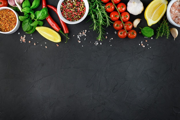 Colorful various herbs and spices for cooking on dark background, copy space. High quality photo