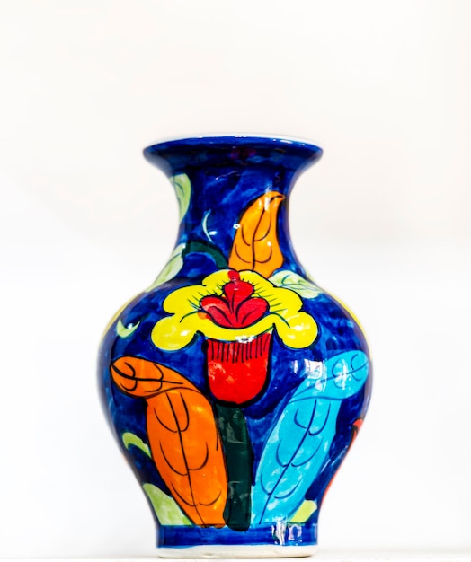 A colorful vase with a flower on it is decorated with a flower on it.
