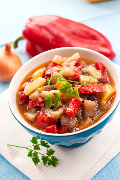 Colorful vegetable stew in a blue bowl