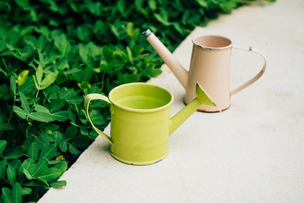 Colorful watering cans for plants at flowers