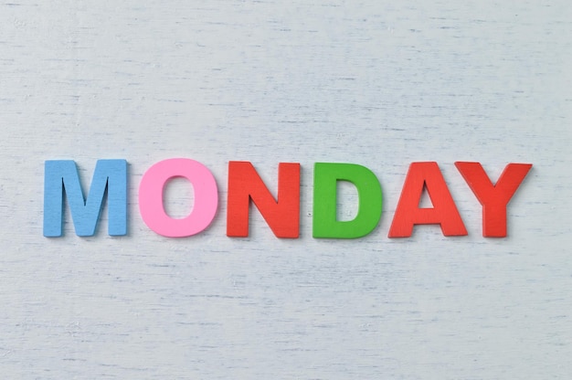 Colorful wooden alphabet with text MONDAY A happy Monday concept