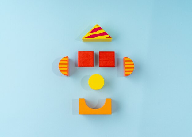 Colorful wooden block toy on light blue background.