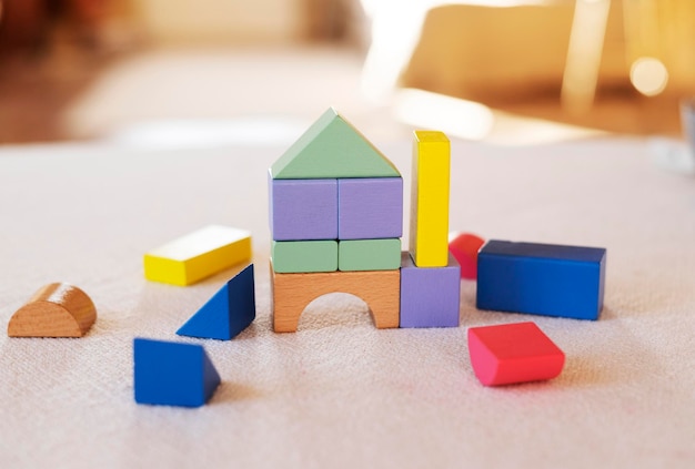 Colorful wooden blocks on home table Creativity toys Children building blocks.