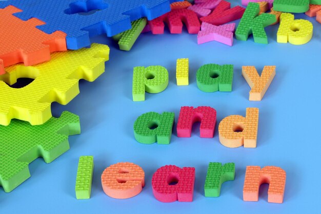 Colorful wooden blocks with the word play and learn written in the middle.