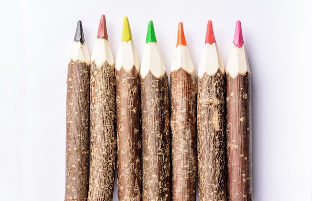 Colorful wooden crayon on white table